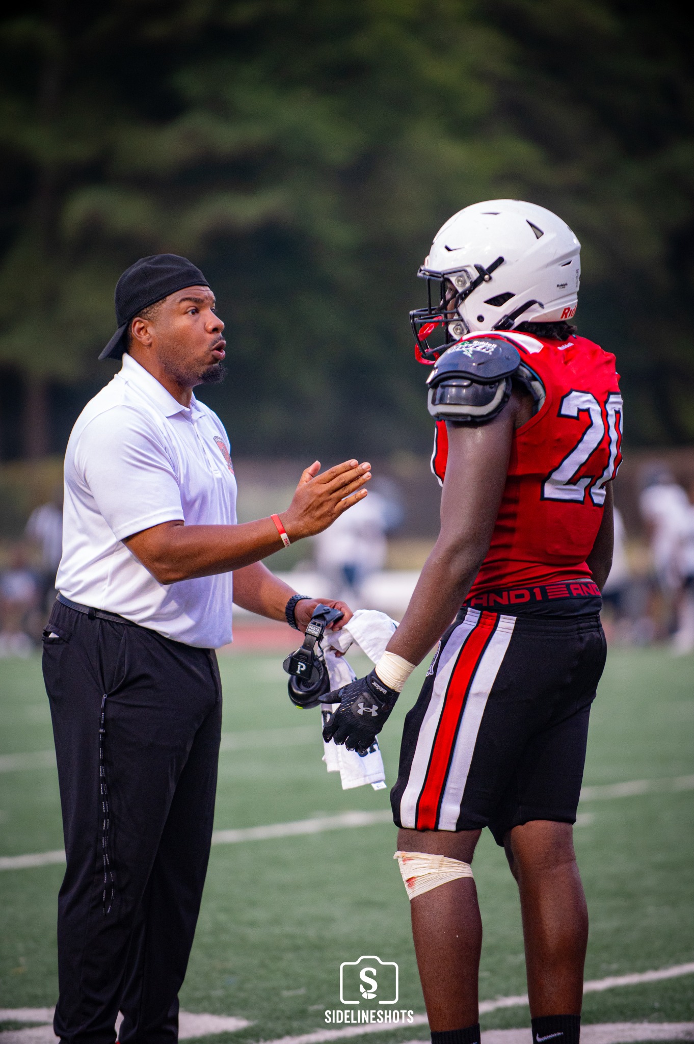Stone Mountain coach talking with a player